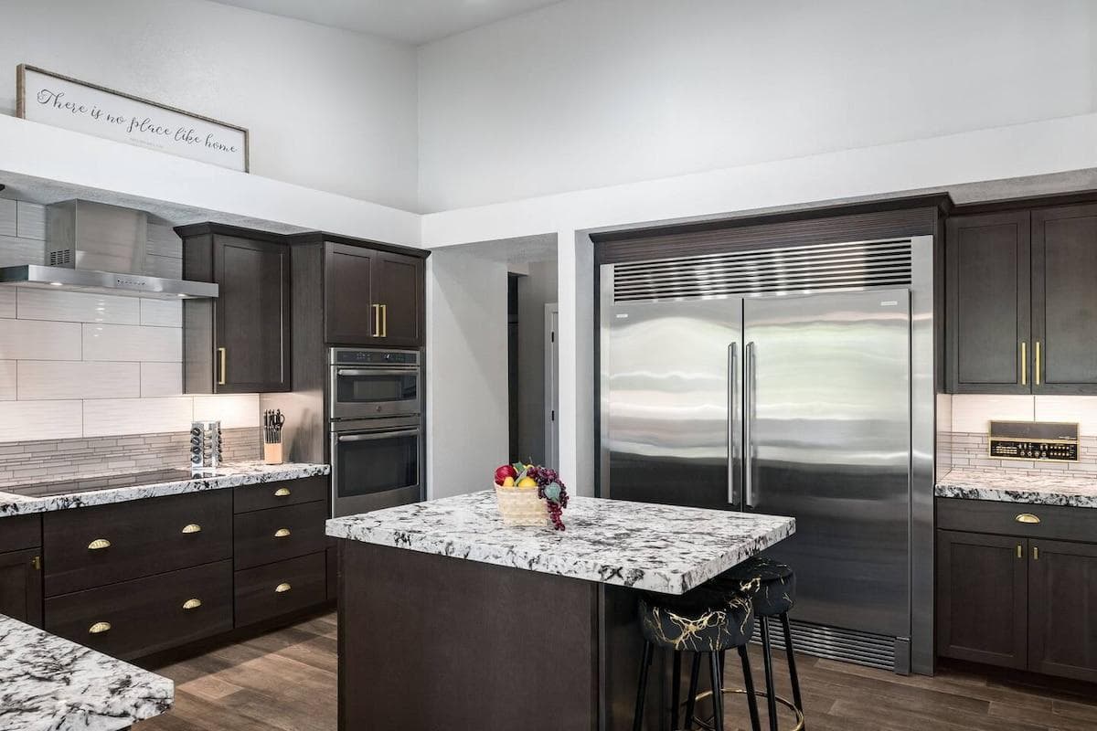 Gourmet kitchen complete with high end appliances, commercial grade refrigerator, large island for cooking and entertaining