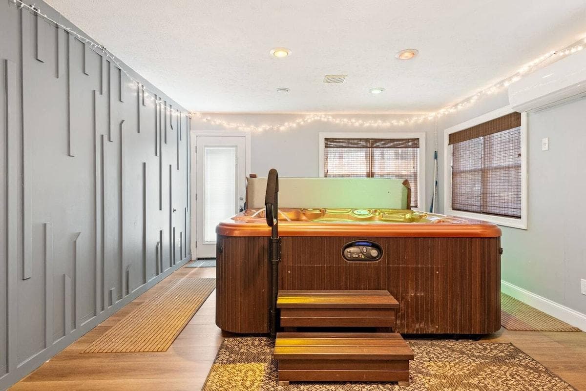 Hot Tub—ideal for melting away the day's stress and savoring peaceful moments. The indoor setting ensures a bug-free experience. This luxurious hot tub is designed for your comfort and enjoyment.